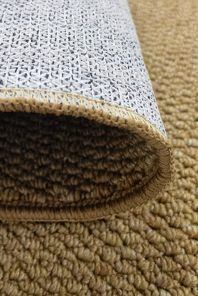 Close-up of a beige carpet roll with textured surface