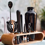 Set of black bar tools on a wooden stand with a blurred background