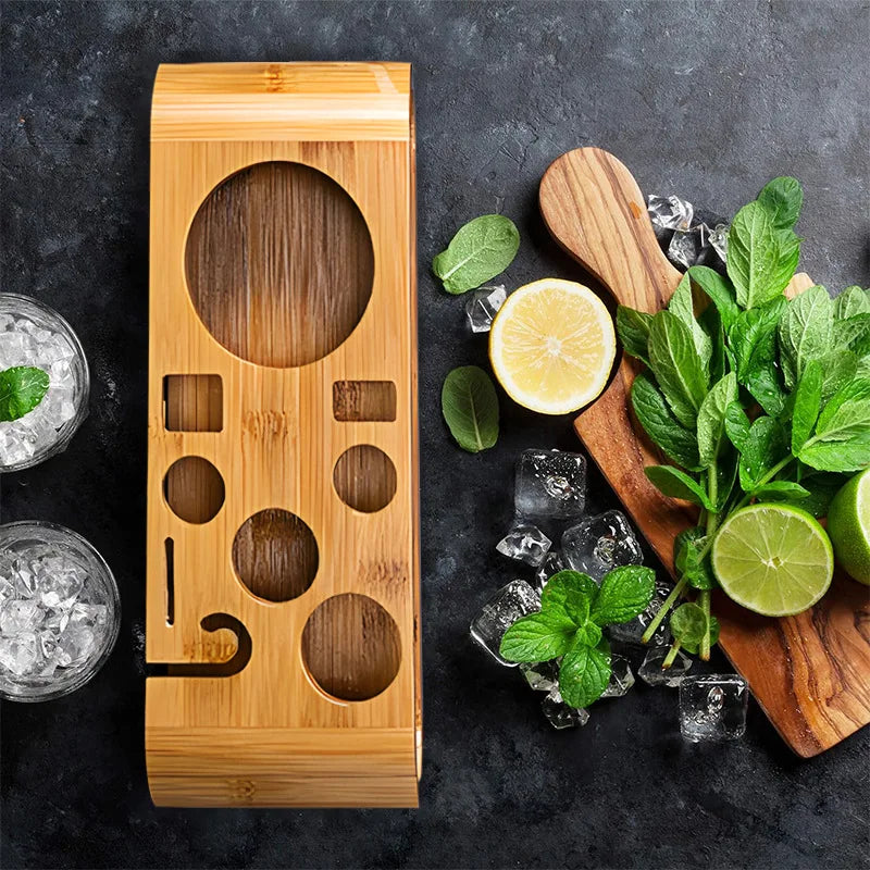 Wooden drink mixer with lemons, limes, and mint leaves on a dark surface