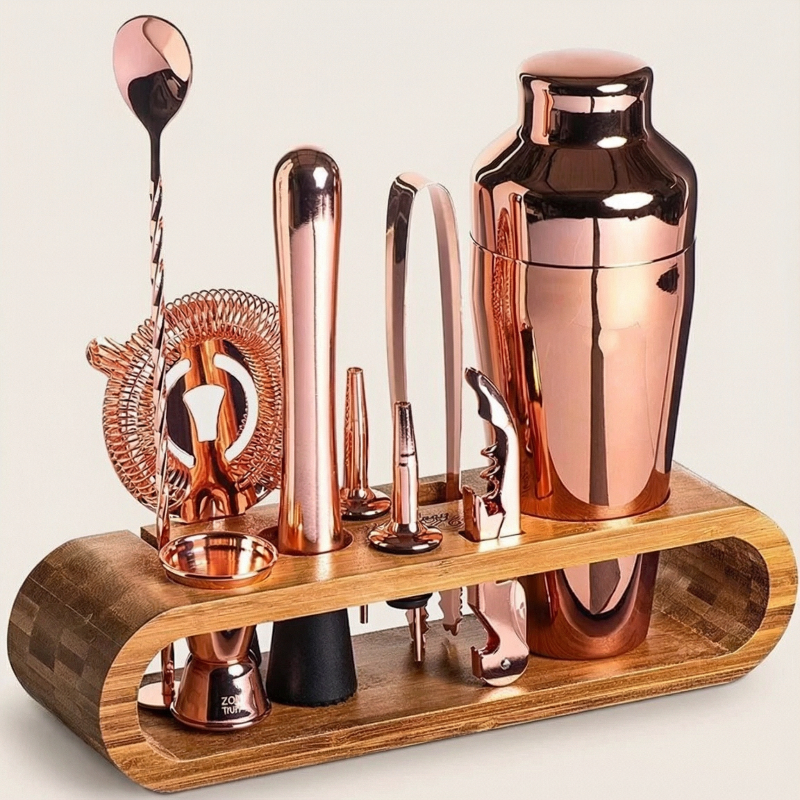 Copper cocktail shaker and tools on a wooden stand against a light background