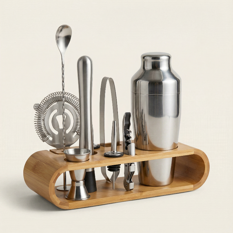 Set of cocktail-making tools including a shaker, jigger, and strainer on a wooden stand.