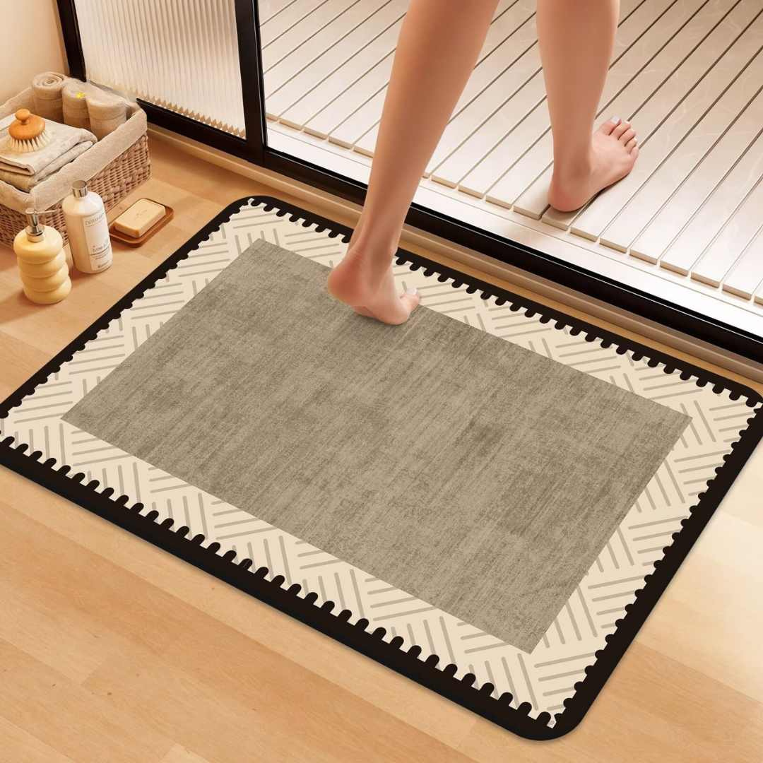 Person stepping onto a gray mat on a wooden floor with a geometric border