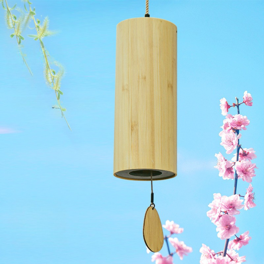 Wooden wind chime with a blue sky and cherry blossoms in the background