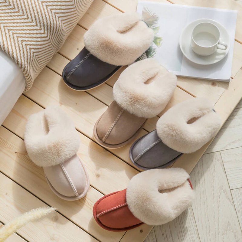 Pair of fluffy slippers on a wooden floor with a cozy atmosphere.