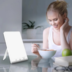 Woman eating cereal with a white lamp on a table in a kitchen setting