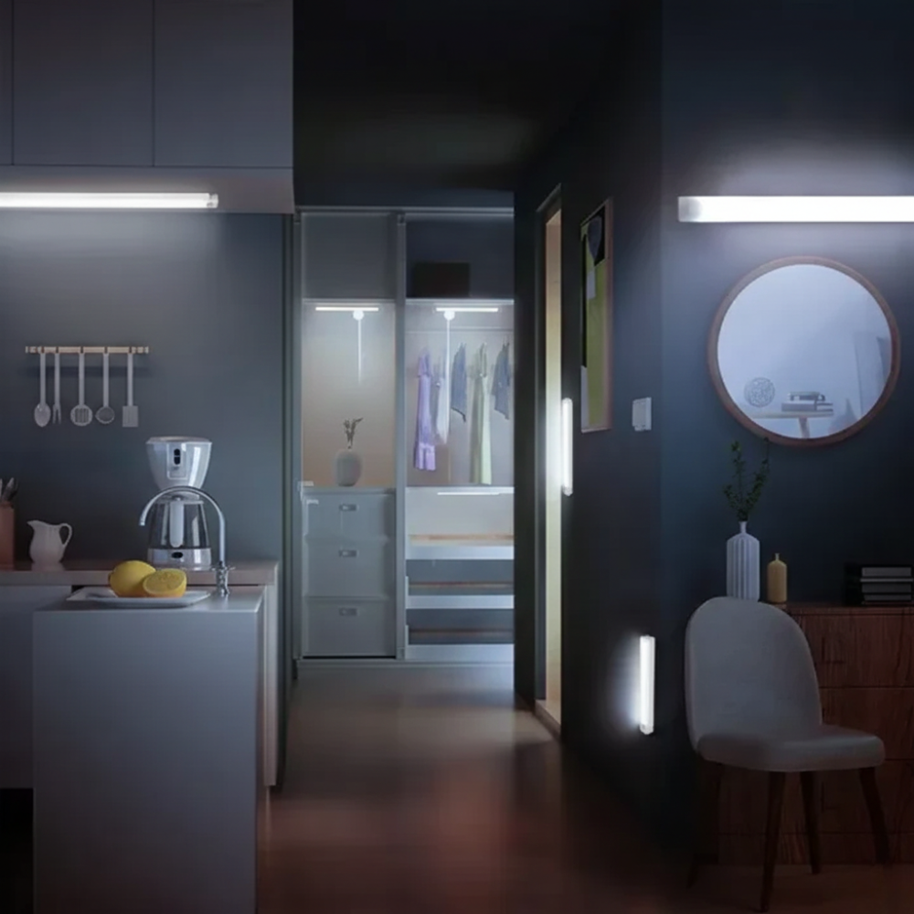 Modern kitchen with dark walls, a coffee maker, and a chair.