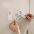 Person using a door hanger with a card on a beige wall