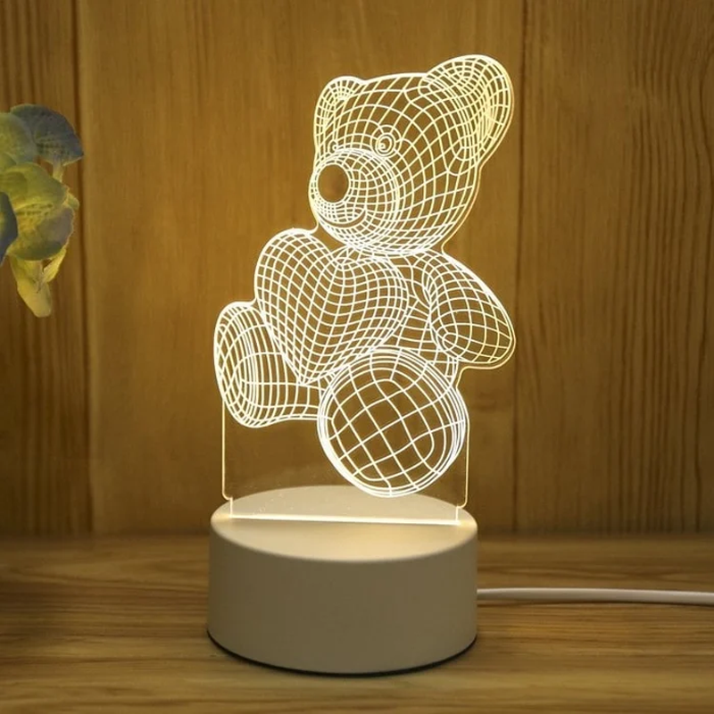 Teddy bear-shaped night light on a wooden surface