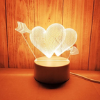 Decorative lamp with heart and arrow design on a wooden background