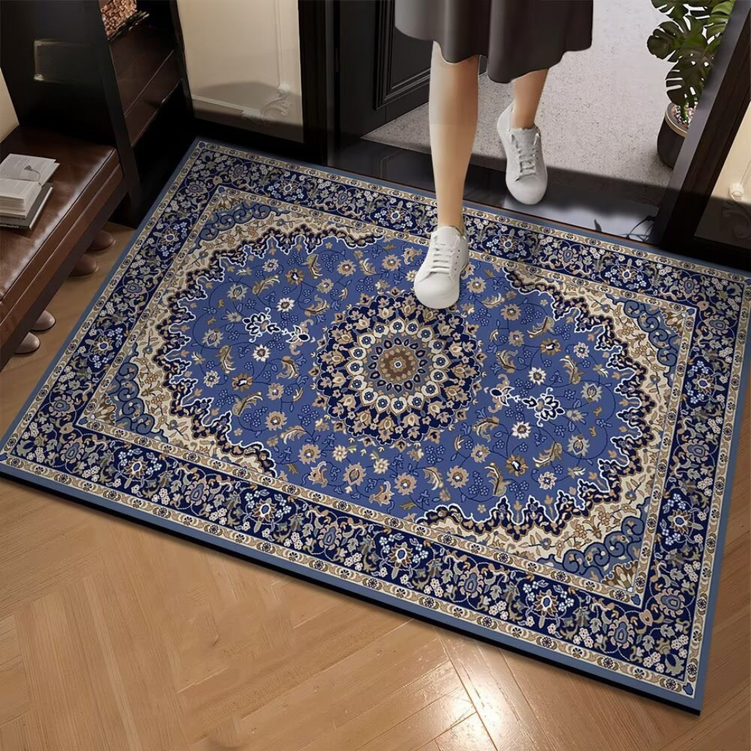 Decorative blue and white patterned rug on a wooden floor with a person stepping onto it.