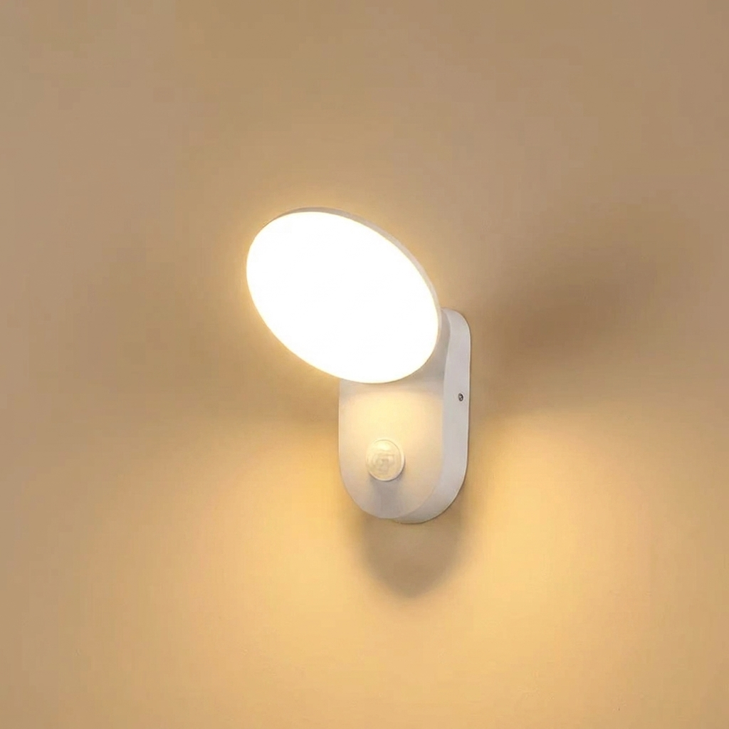White motion sensor wall light on a beige wall