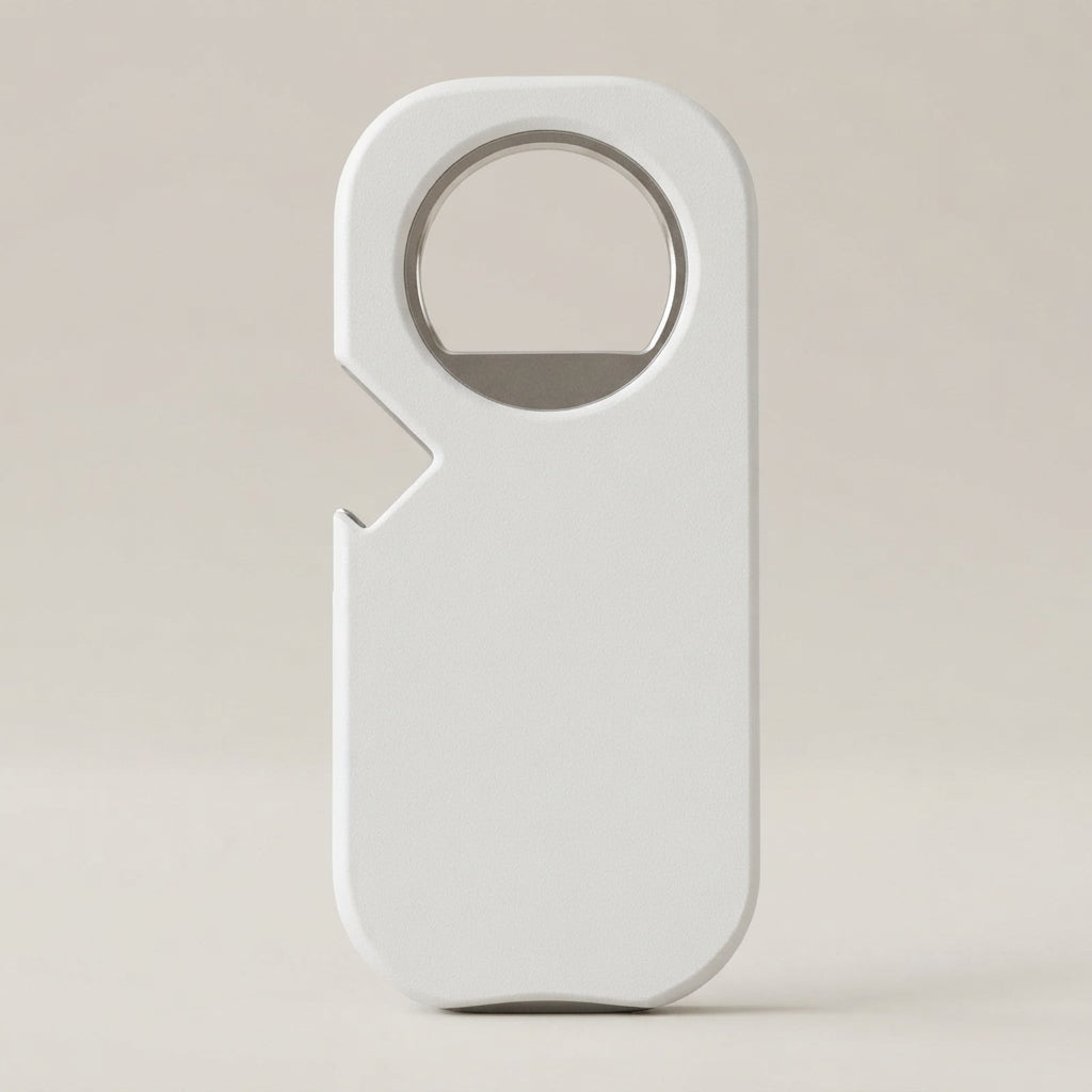 A minimalist white bottle opener with a clean, rounded rectangular design and a built-in circular cutout, standing upright on a neutral beige background.
