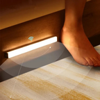 Smart floor lamp with a foot switch on a carpeted floor.