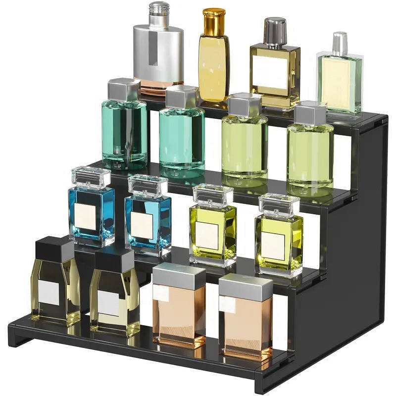 Perfume bottles on a black display stand with a white background