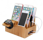 Wooden charging station with multiple electronic devices on a white background