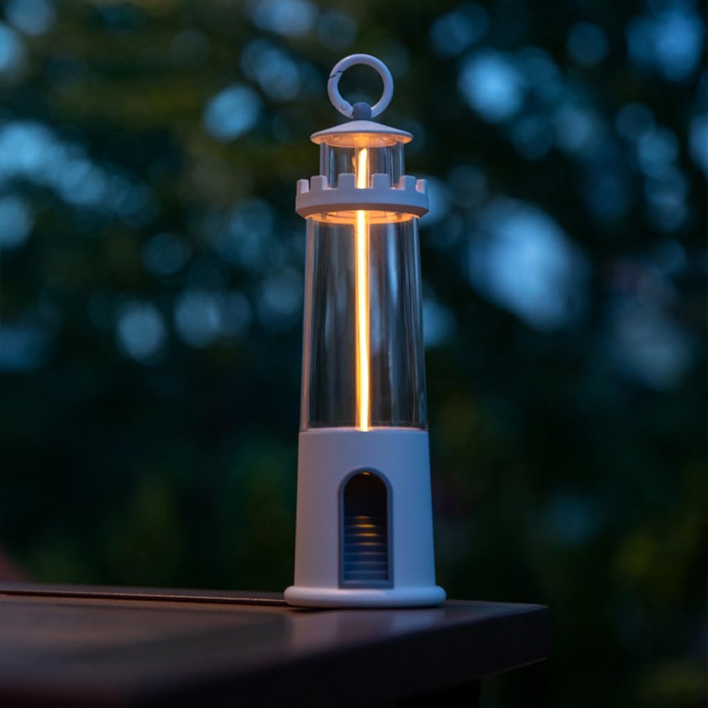 Lighthouse-shaped lantern with a glowing interior on a blurred natural background