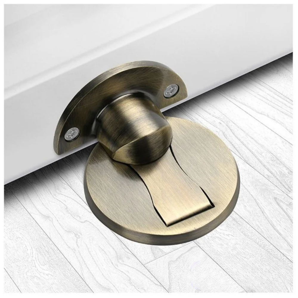 Brass door stopper on a white floor