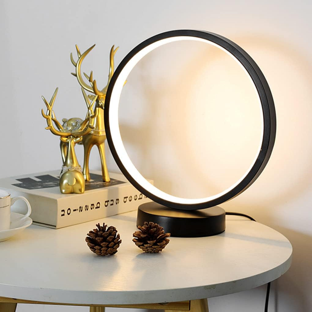 Round table lamp on a white surface with decorative items