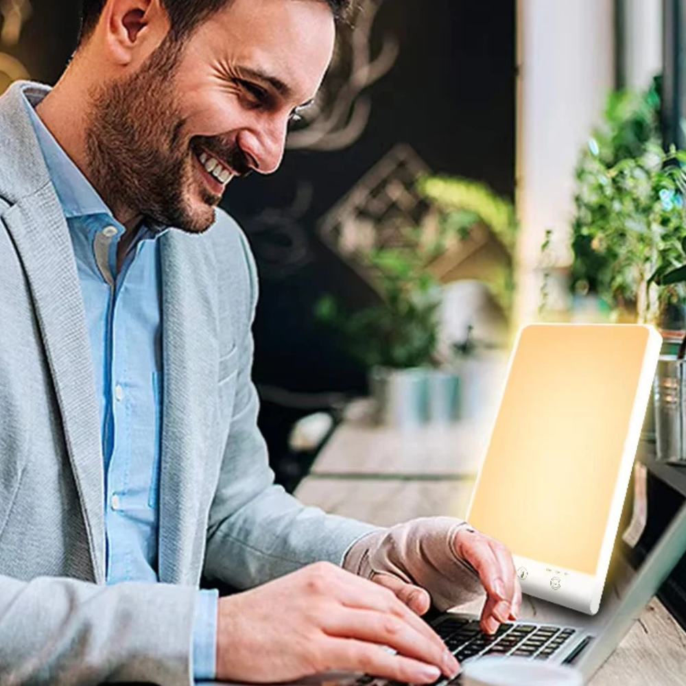 Man using a laptop outdoors with a blurred background