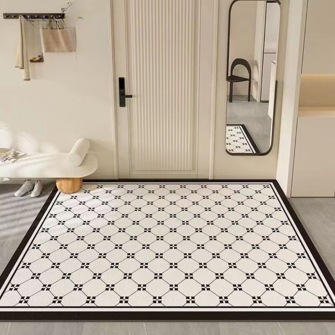 Patterned black and white rug on a floor with a mirror and door in the background.