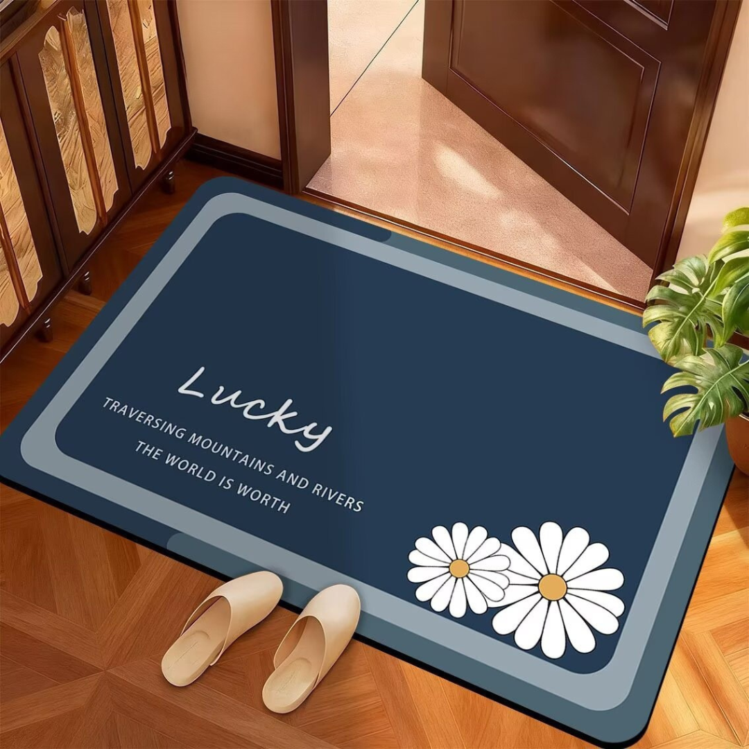 Decorative doormat with flowers and text on a wooden floor