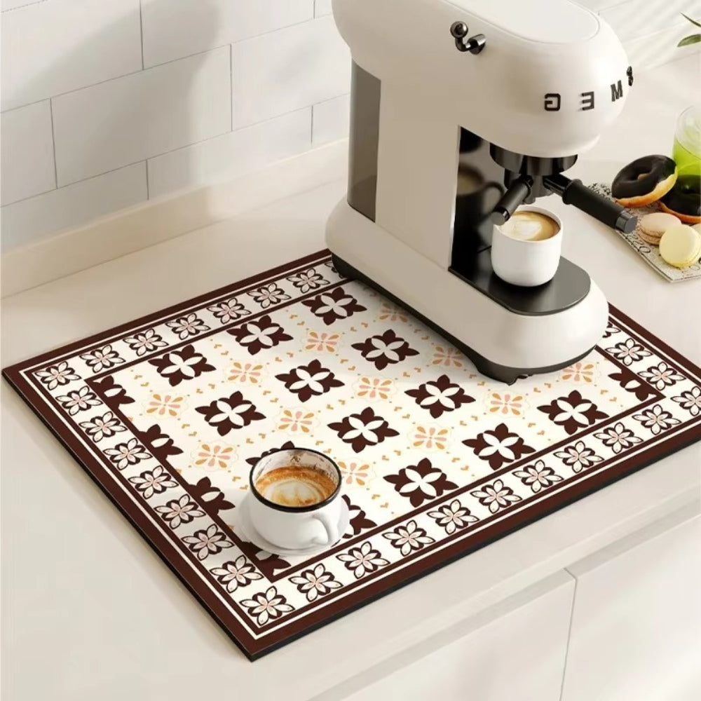 Patterned mat with coffee cups on a kitchen counter next to a Smeg espresso machine.
