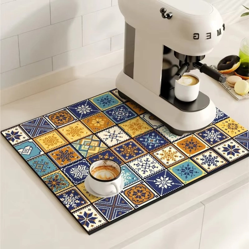 Colorful tiled mat with a coffee cup and coffee machine on a kitchen floor.