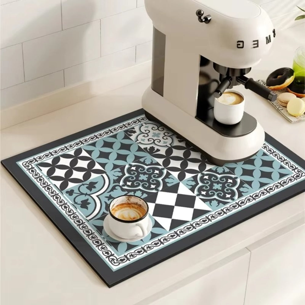 Patterned mat with coffee cups and a coffee machine on a kitchen counter.