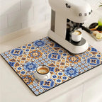 Decorative kitchen mat with a colorful tile pattern on a kitchen counter with a coffee machine and cups.