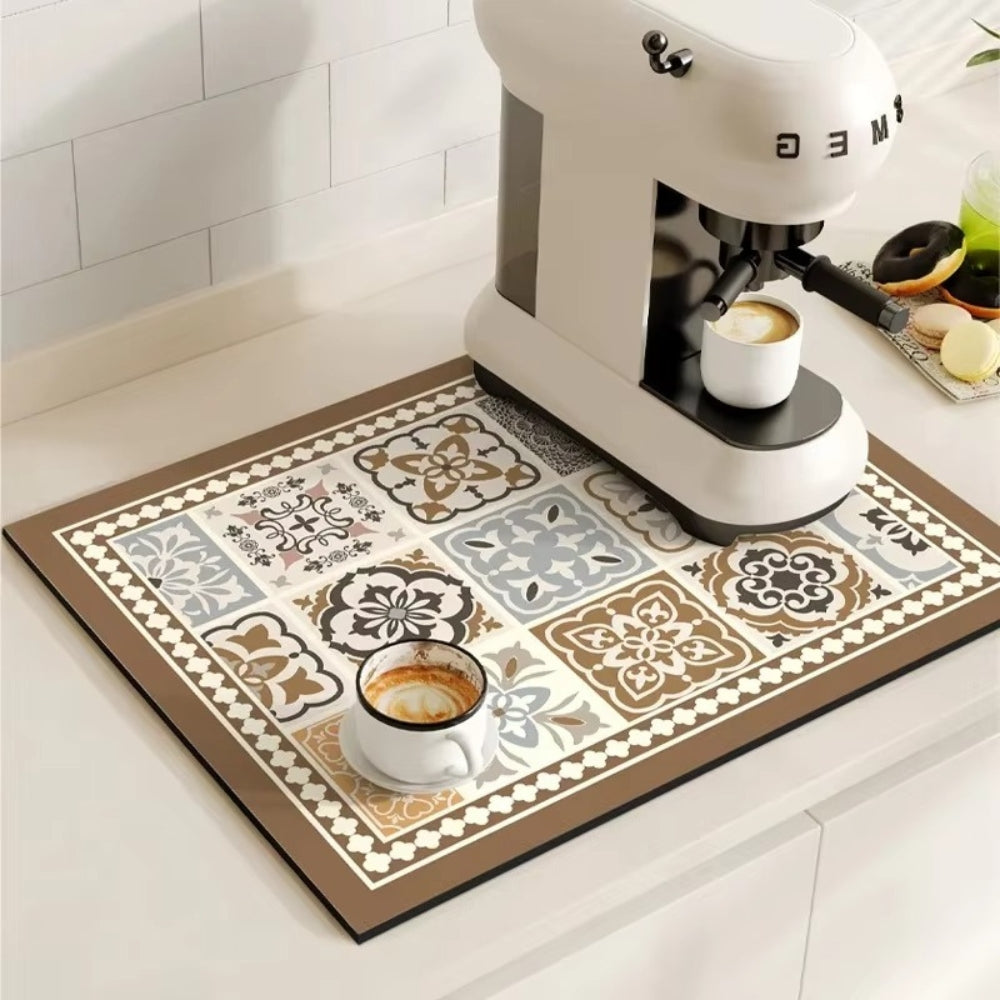 Espresso machine and cups on a decorative mat with a tiled backsplash