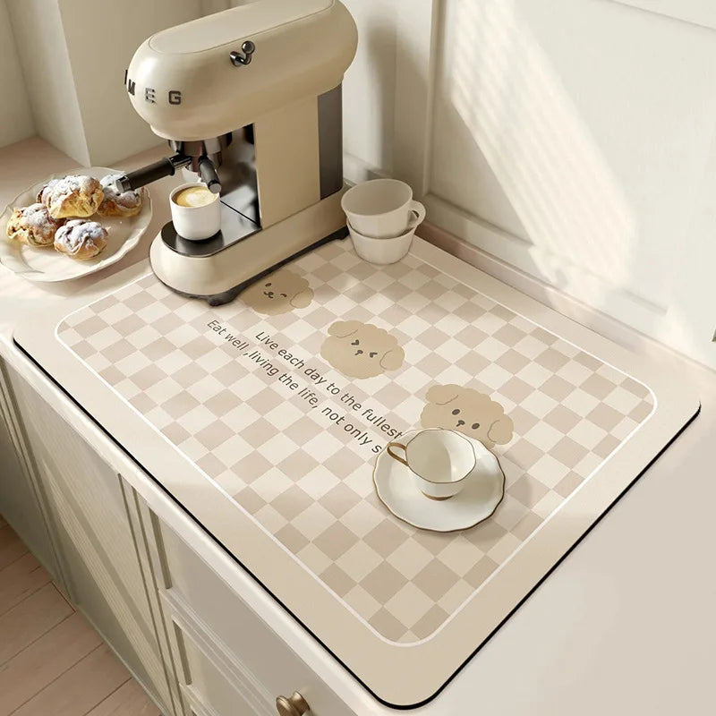 Checkered kitchen mat with cartoon designs on a kitchen counter.