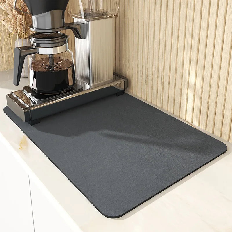 Gray mat on a kitchen counter with a coffee maker in the background
