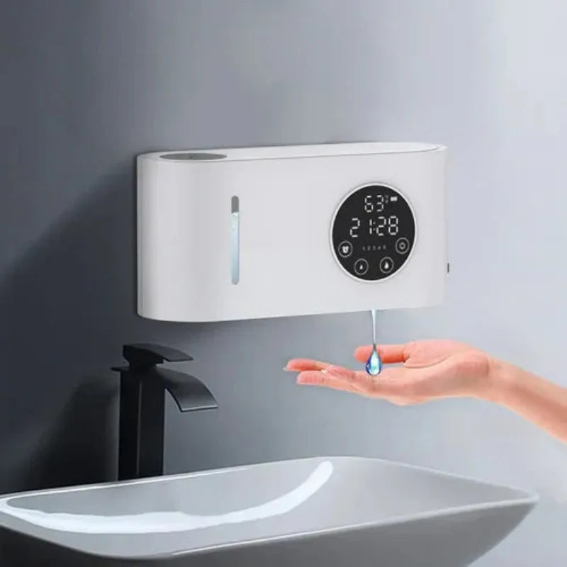 Hand soap dispenser with digital display on a gray wall above a sink.