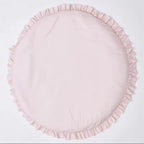A round light pink fabric cushion with a ruffled edge, photographed flat against a plain white background.