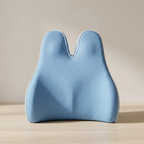 Blue ergonomic pillow on a wooden surface with a beige background