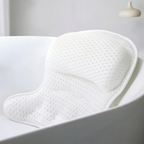 White bath pillow in a bathtub with a neutral background