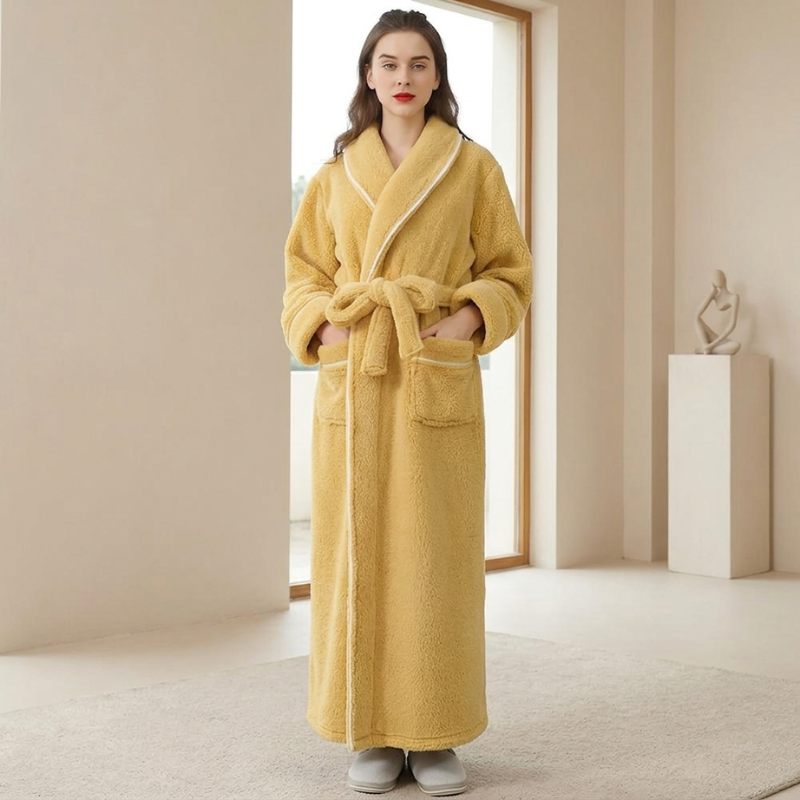 Woman wearing a yellow robe in a minimalistic room.