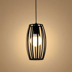 Black pendant light with a glowing bulb on a beige background