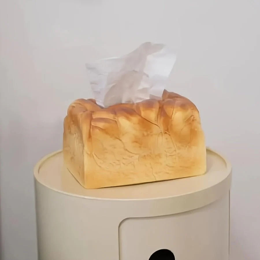 Tissue box designed like a loaf of bread on a white surface with a light gray background