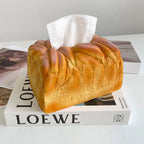 Bread-shaped tissue box on a book
