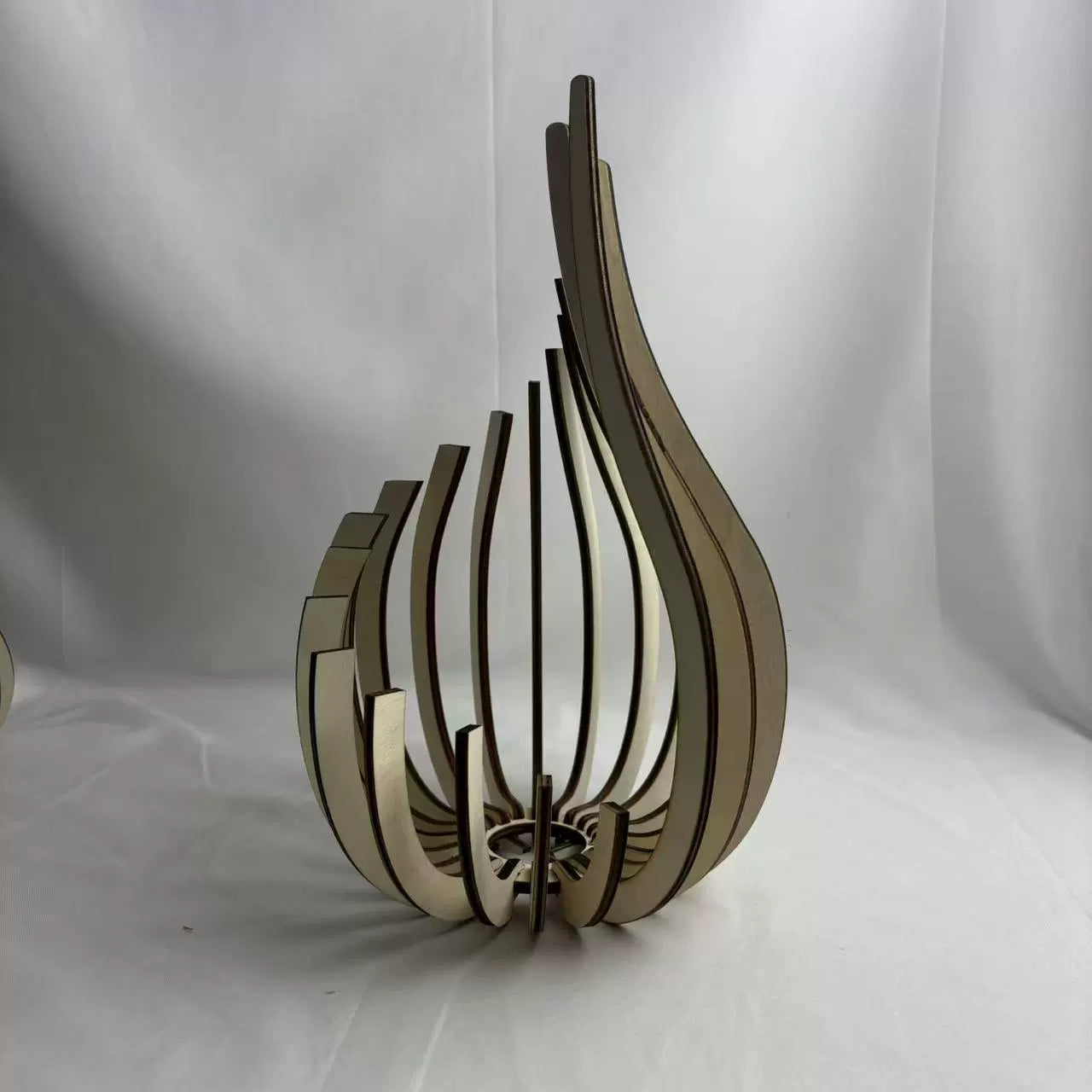 Wooden decorative object with a unique design on a white background