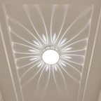 Ceiling light fixture with decorative pattern on a white ceiling