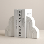 White and gray bookends with 'Idea Alph' branding on a beige background