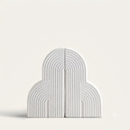 White arch-shaped bookends on a light gray background