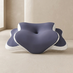 Blue and white pillow on a beige surface with a neutral background