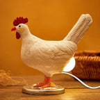 Chicken-shaped lamp on a wooden surface with a warm background
