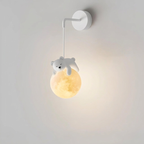 Wall lamp with a bear-shaped fixture on a plain background