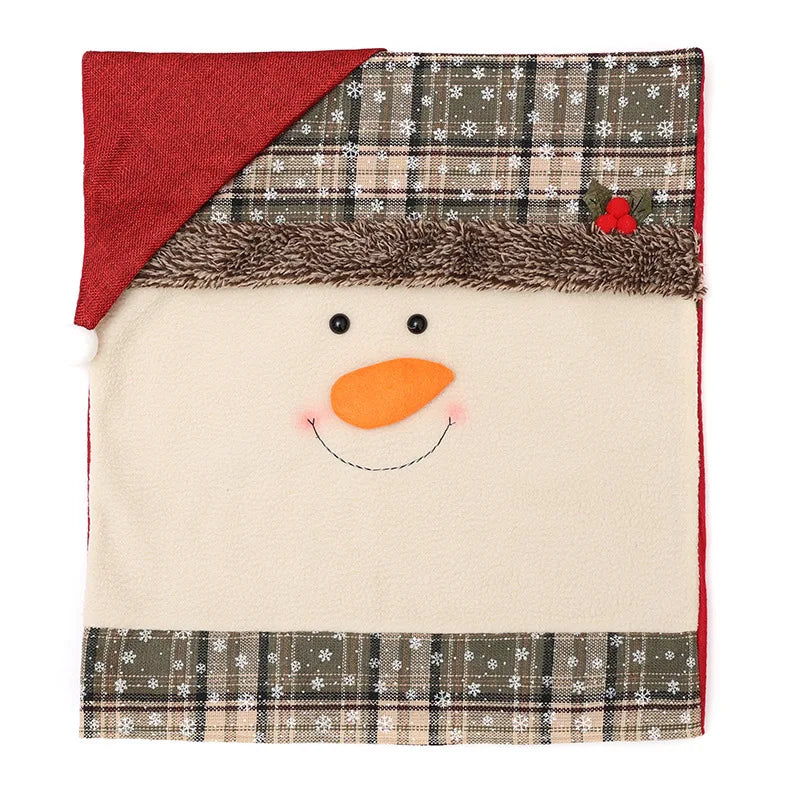 A square fleece blanket designed like a snowman's face, featuring a red Santa hat, a brown faux-fur trim, a beige face with embroidered black eyes and an orange carrot nose, and plaid patterned borders at the top and bottom.