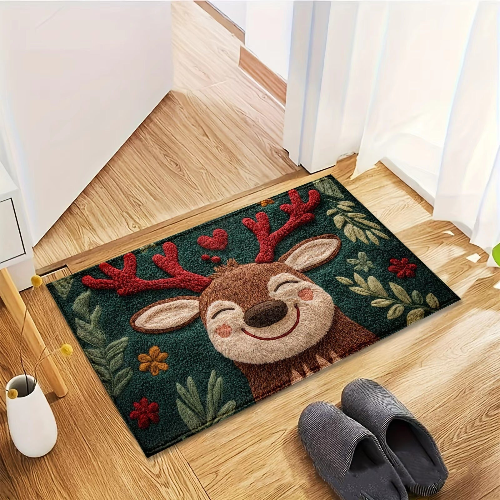 Doormat with a reindeer design on a wooden floor next to a white mug and gray slippers.