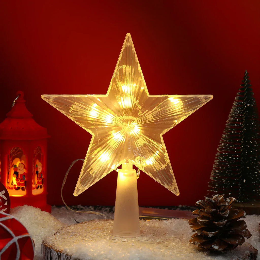 Star-shaped light fixture on a snowy base with a red background